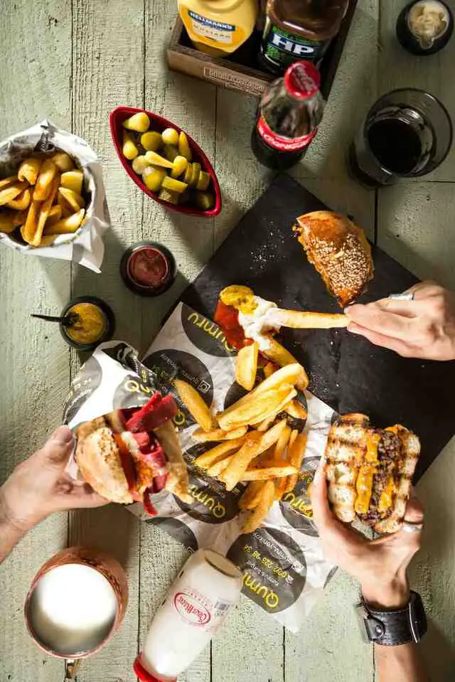 Two persons eating a burger