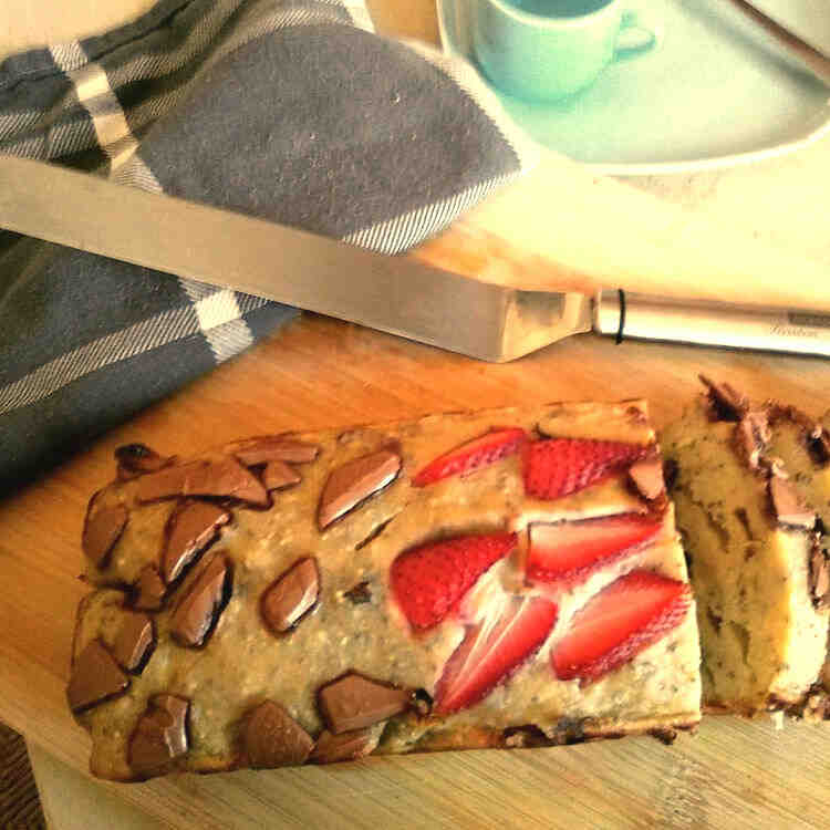 Almond Banana Bread with chocolate pieces and strawberries on top.