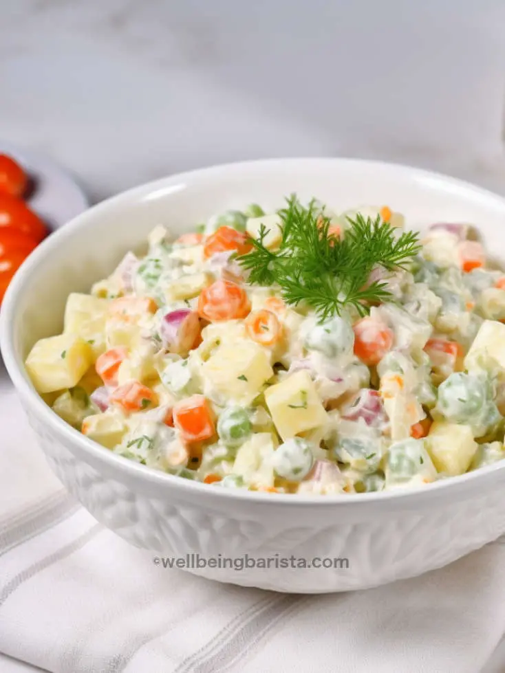 Russian salad with diced potatoes, carrots, pickles, peas and mayo