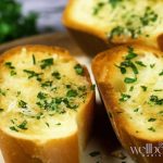 Nando's-style sliced garlic bread with melted butter and parsley flakes