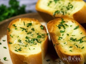 Nando's-style sliced garlic bread with melted butter and parsley flakes