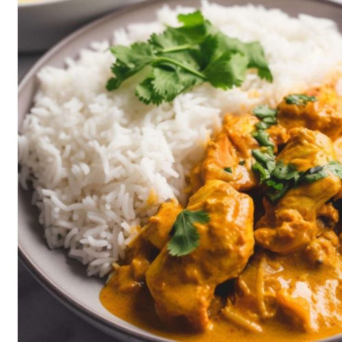 A light Chicken Yoghurt Curry Served With Rice and Cilantro