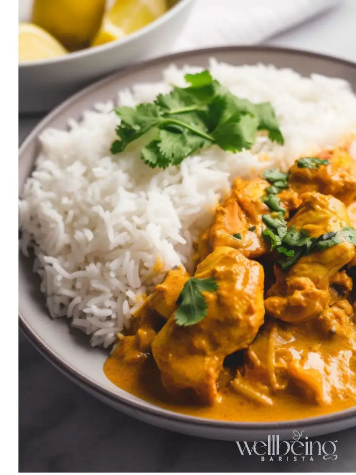 A light Chicken Yoghurt Curry Served With Rice and Cilantro