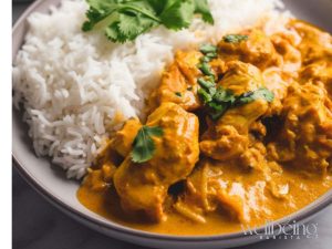 A light Chicken Yoghurt Curry Served With Rice and Cilantro