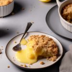 apple crumble served on a plate with lemon curd