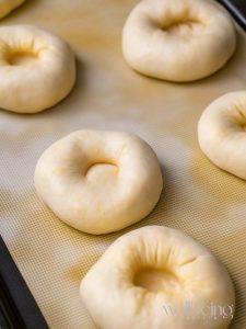 Shaping the dough for raspberry buns with a depression in the centre.