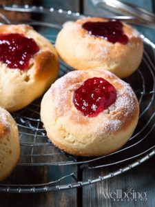 Mary Berry raspberry jam buns left to cool on a wiring rack.