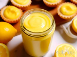 lemon curd sauce in a jar with portuguese tarts filled with lemon curd.