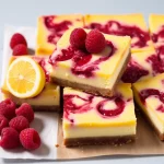 Biscuit Base filled with lemon curd, topped with fresh raspberries and cut into bars