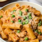 Creamy chicken rigatoni pasta in a combination of marinara and Alfredo sauce with peas, red pepper flakes and parmesan cheese.