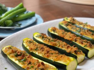 vegetarian stuffed marrows / zucchini with cooked pulp and covered in parmesan cheese and breadcrumbs