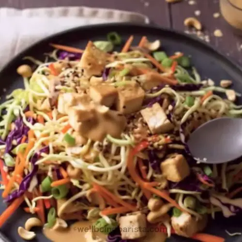 chicken satay pasta salad with rice noodles, veggies, peanut sauce and crushed peanuts on top