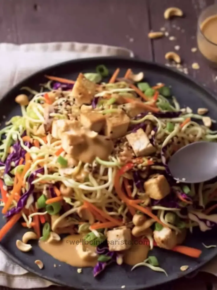 chicken satay pasta salad with rice noodles, veggies, peanut sauce and crushed peanuts on top