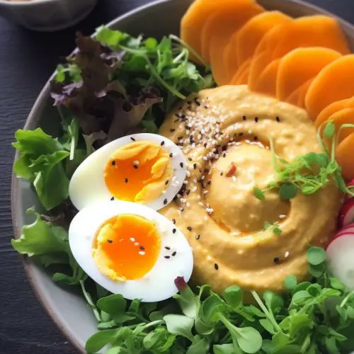 mango arugula chickpea hummus radishes boiled egg and toasted black sesame seeds