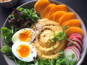 mango arugula chickpea hummus radishes boiled egg and toasted black sesame seeds